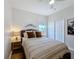 Bedroom featuring wicker bed frame, ceiling fan, window, and wood floors at 2641 Daulby St, Kissimmee, FL 34747