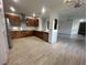 Open concept kitchen with wooden cabinets, stainless appliances, and tile flooring at 3094 Anquilla Ave, Clermont, FL 34711