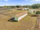 Aerial view of property featuring several outbuildings, a barn, and a fenced perimeter at 36525 Reserve Dr, Eustis, FL 32736