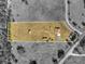 Aerial shot displaying the property's layout, including the house, outbuildings, and cleared acreage at 36525 Reserve Dr, Eustis, FL 32736