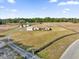 An aerial view of a one-story home with brick accents and a spacious yard with perimeter fencing at 36525 Reserve Dr, Eustis, FL 32736