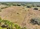 An aerial view shows the house, outbuilding and fenced pasture land surrounding the property at 36525 Reserve Dr, Eustis, FL 32736