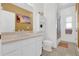 Bright bathroom featuring a white vanity, built-in shelves, and a shower with curtain at 36525 Reserve Dr, Eustis, FL 32736