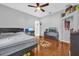 Bedroom with a ceiling fan, wood floors, and space for a computer and television at 36525 Reserve Dr, Eustis, FL 32736