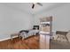 Bright bedroom featuring hardwood floors, a ceiling fan, and a sliding glass door to the backyard at 36525 Reserve Dr, Eustis, FL 32736