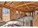 Unfinished interior of a building with wood walls, exposed beams and natural light at 36525 Reserve Dr, Eustis, FL 32736