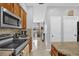 Galley kitchen with stainless steel appliances and views into the dining room at 36525 Reserve Dr, Eustis, FL 32736