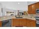 Open kitchen featuring granite countertops, stainless appliances, and a view to the lanai at 36525 Reserve Dr, Eustis, FL 32736