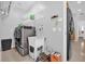 Well-organized laundry room with modern washer and dryer, utility sink, and storage shelves at 36525 Reserve Dr, Eustis, FL 32736