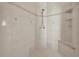 A tiled shower with a shower head, integrated shelving, and decorative patterned tiles at 36525 Reserve Dr, Eustis, FL 32736