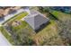 An aerial view that highlights the roof of the house along with mature trees, and a quiet neighborhood at 3978 Old Dunn Rd, Apopka, FL 32712