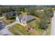 An aerial shot of a charming home featuring a well-manicured lawn, mature trees, and a driveway at 3978 Old Dunn Rd, Apopka, FL 32712