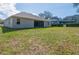 Large backyard with green grass and exterior view of the house at 3978 Old Dunn Rd, Apopka, FL 32712