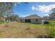 Expansive backyard featuring a well-maintained lawn and mature trees, providing a serene outdoor space at 3978 Old Dunn Rd, Apopka, FL 32712