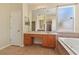 Bathroom with a bathtub, stand up shower, vanity with storage and a large mirror at 3978 Old Dunn Rd, Apopka, FL 32712