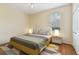 Bright bedroom with neutral walls, wooden floors, ceiling fan, and closet with a window at 3978 Old Dunn Rd, Apopka, FL 32712