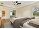 Comfortable bedroom featuring a ceiling fan, tray ceiling, and an en-suite bathroom at 3978 Old Dunn Rd, Apopka, FL 32712