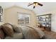 Bedroom with a large window, ceiling fan, and a shelf with storage bins at 3978 Old Dunn Rd, Apopka, FL 32712