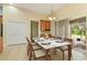 Dining area with modern table, next to sliding glass doors to screened in patio at 3978 Old Dunn Rd, Apopka, FL 32712