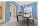 A stylish dining area showcases light tile floors, a modern table with six chairs, and an abundance of natural light at 3978 Old Dunn Rd, Apopka, FL 32712