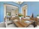 Inviting dining area with blue accent wall offers an open-concept living space and seating for six at 3978 Old Dunn Rd, Apopka, FL 32712