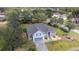 Single-Gathering home with attached two-car garage, gray paint and well-kept lawn at 3978 Old Dunn Rd, Apopka, FL 32712