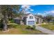 Charming two-story home showcasing a well-manicured lawn, tasteful landscaping, and a paved driveway at 3978 Old Dunn Rd, Apopka, FL 32712