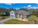 Single-Gathering home with attached two-car garage, gray paint and well-kept lawn at 3978 Old Dunn Rd, Apopka, FL 32712