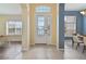 A welcoming foyer with tiled flooring leads to a bright and airy living space with abundant natural light at 3978 Old Dunn Rd, Apopka, FL 32712