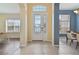 Inviting front entrance featuring tile flooring and decorative glass door with transom window at 3978 Old Dunn Rd, Apopka, FL 32712
