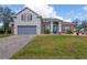 Charming two-story home with a manicured lawn, brick accents, and a patterned brick driveway at 3978 Old Dunn Rd, Apopka, FL 32712