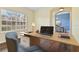 A bright home office, bathed in natural light from a large window, features hardwood floors at 3978 Old Dunn Rd, Apopka, FL 32712
