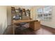 Bright, contemporary home office with hardwood floors, featuring a large window and built-in shelving at 3978 Old Dunn Rd, Apopka, FL 32712