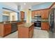 Open concept kitchen with stainless appliances and central island at 3978 Old Dunn Rd, Apopka, FL 32712