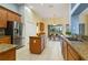 Modern kitchen with granite countertops, stainless steel appliances, and a central island offers ample cooking space at 3978 Old Dunn Rd, Apopka, FL 32712