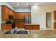 Beautiful kitchen with granite countertops, stainless steel appliances and lots of wood cabinet storage at 3978 Old Dunn Rd, Apopka, FL 32712