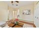 Spacious living room showing multiple doorways, tile flooring, an area rug and neutral walls at 3978 Old Dunn Rd, Apopka, FL 32712