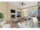 Bright living room with a fireplace, ceiling fan, comfortable seating, and lots of natural light at 3978 Old Dunn Rd, Apopka, FL 32712