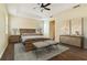 Primary bedroom boasts tray ceiling, ceiling fan, neutral paint and wood floor at 3978 Old Dunn Rd, Apopka, FL 32712