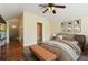 Bright main bedroom with wood floors, ceiling fan and ensuite bathroom at 3978 Old Dunn Rd, Apopka, FL 32712