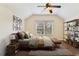 Spacious main bedroom with a large window, ceiling fan, and stylish decor at 3978 Old Dunn Rd, Apopka, FL 32712