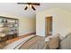 Bright main bedroom features wood floors, open shelving and a ceiling fan at 3978 Old Dunn Rd, Apopka, FL 32712