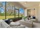 Screened patio with comfortable seating, a ceiling fan, and a view of the landscaped backyard at 3978 Old Dunn Rd, Apopka, FL 32712