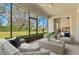 Screened patio with comfortable furniture and a view of the lush green yard and serene scenery at 3978 Old Dunn Rd, Apopka, FL 32712