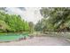 Scenic view of a swimming area with clear water and sandy beach, surrounded by trees at 3978 Old Dunn Rd, Apopka, FL 32712
