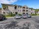 Apartment building with multiple units, parking spaces, and well-maintained landscaping at 4260 Summer Landing Dr # 202, Lakeland, FL 33810