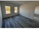 Bright bedroom with gray floors, two sunny windows, and a neutral color palette at 4650 Sw 139Th Pl, Ocala, FL 34473