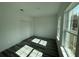 Bright bedroom with wood-look floors, closet, and lots of natural light from the windows at 4650 Sw 139Th Pl, Ocala, FL 34473