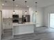 Modern kitchen with white cabinets, stainless steel appliances, and a center island at 4650 Sw 139Th Pl, Ocala, FL 34473