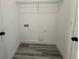 Empty laundry room featuring utility hook-ups and wire shelving at 4650 Sw 139Th Pl, Ocala, FL 34473